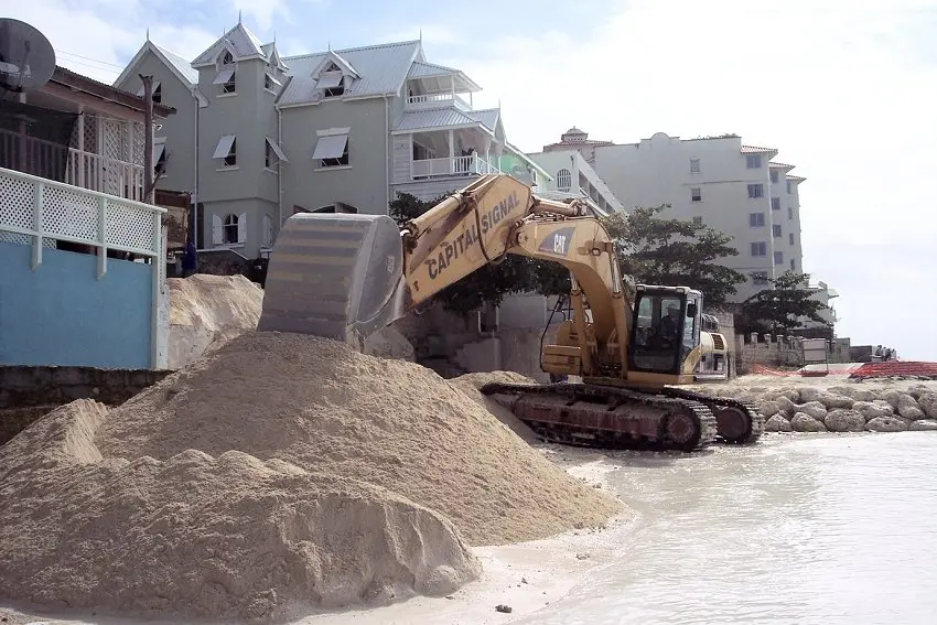 Bulldozer moving a large pile of sand