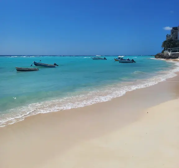 Wide sandy beach leading to tranquil turquoise ocean waters