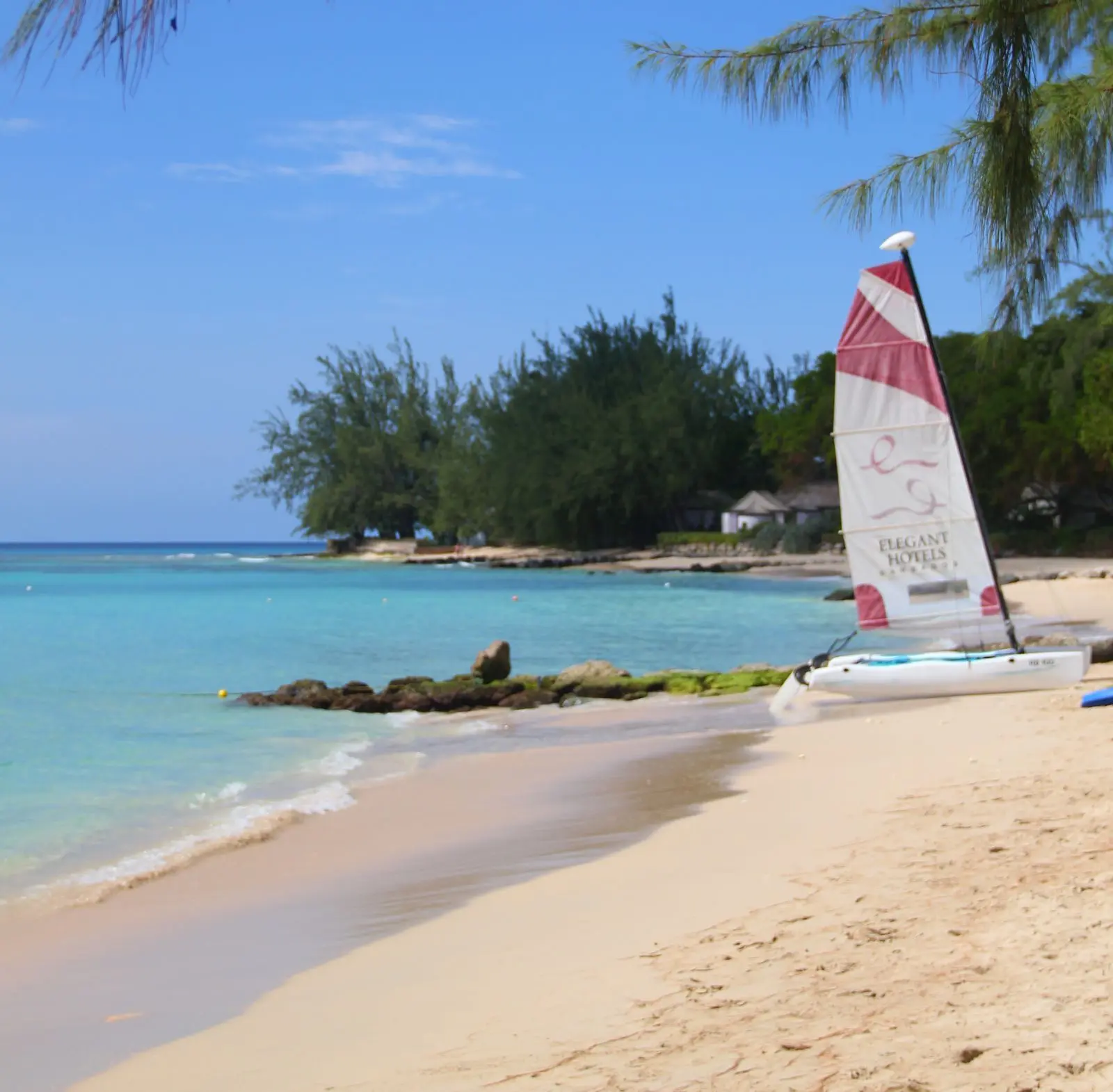 Tranquil tropical beach with a small catamaran on the beach