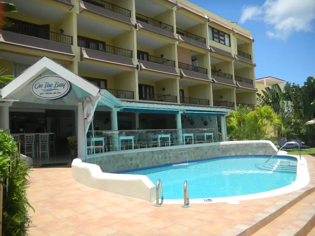 Entrance to the Yellow Bird Hotel with swimming pool out front