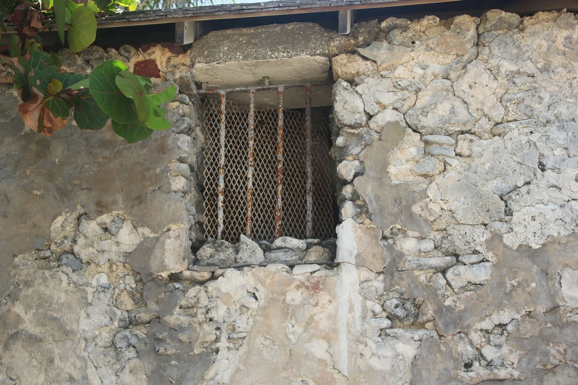 Iron bars look out to the ocean - a glimpse into the past