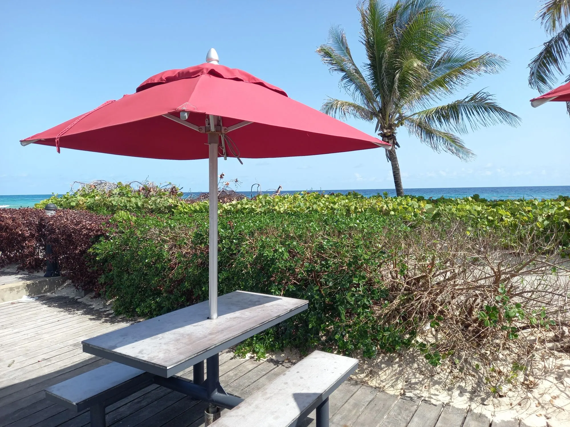 A red umbrella shades a picnic bench at Kentucky Fried Chicken alongside the boardwalk