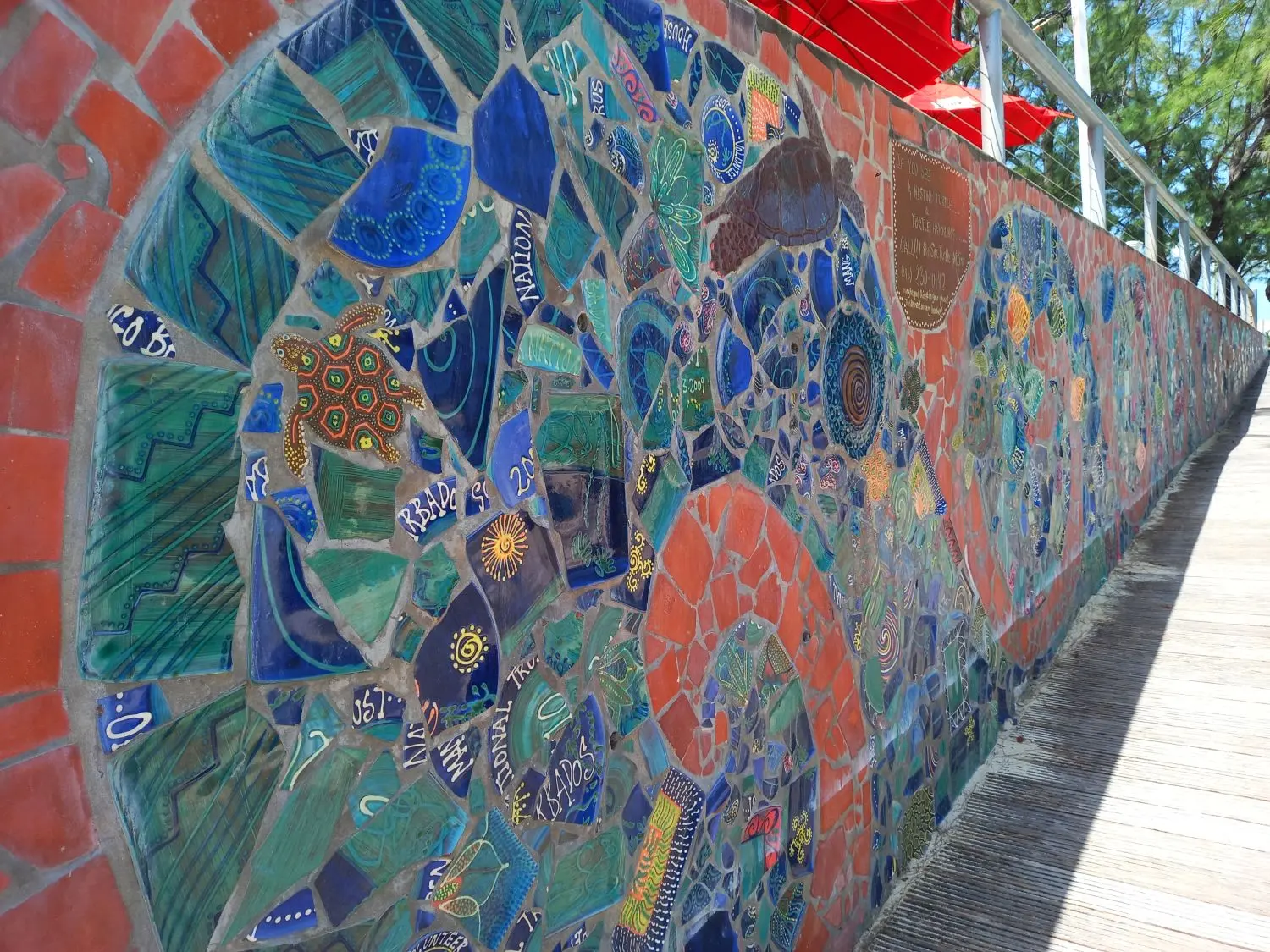 Beautiful mural made with broken pottery with sun and turtle images