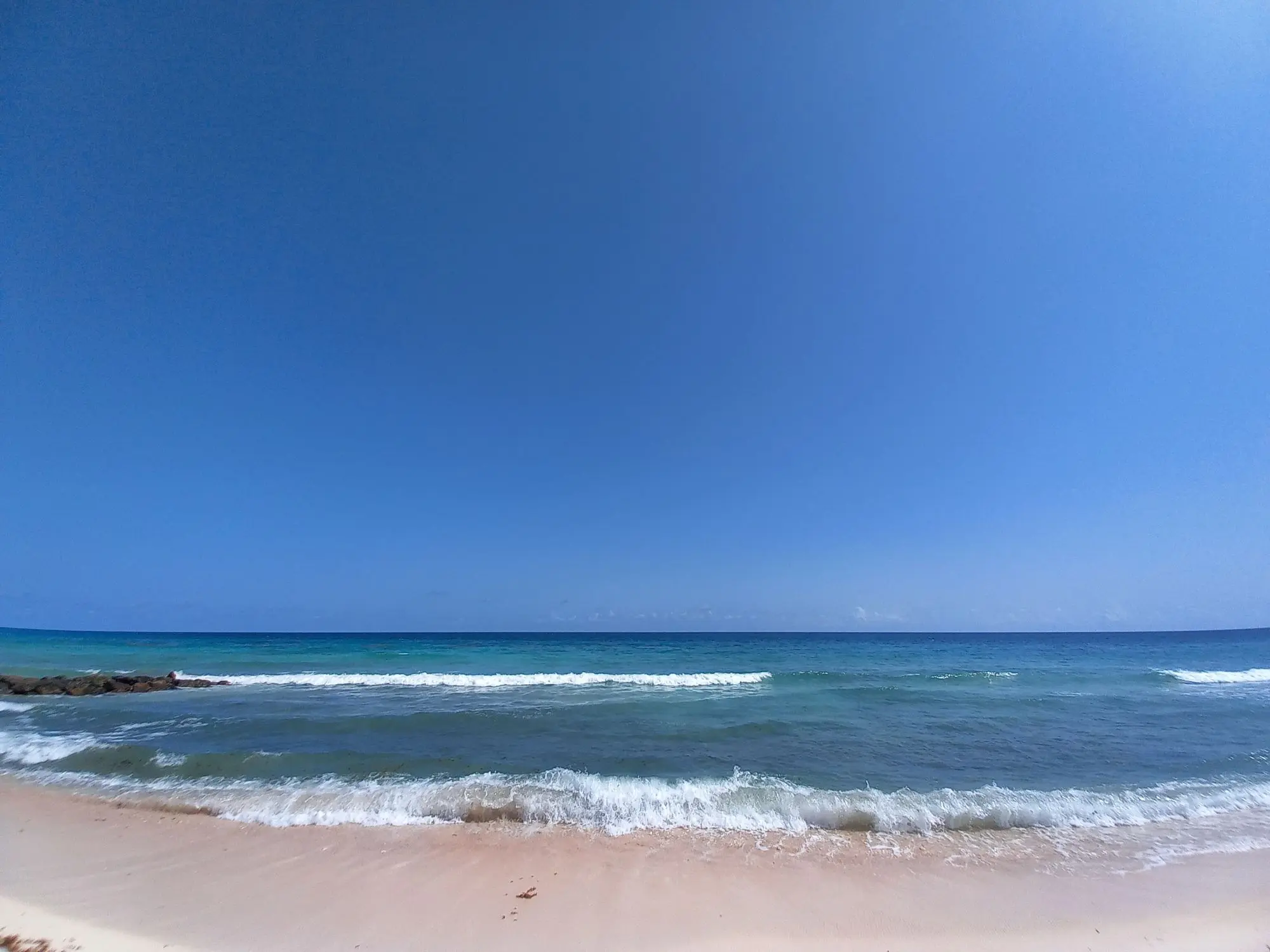 Looking out to the open ocean with several shades of blue as the sea deepens