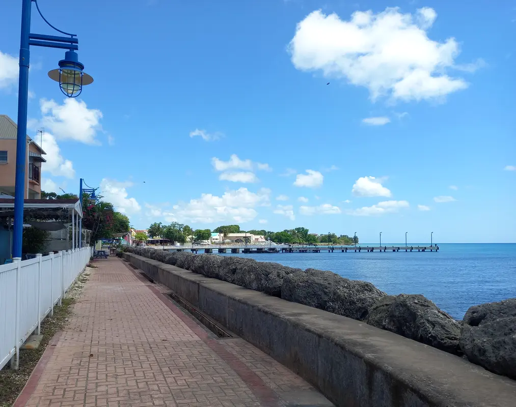 The boardwalk stretching out ahead with the sea on the right and the jetty in the distance