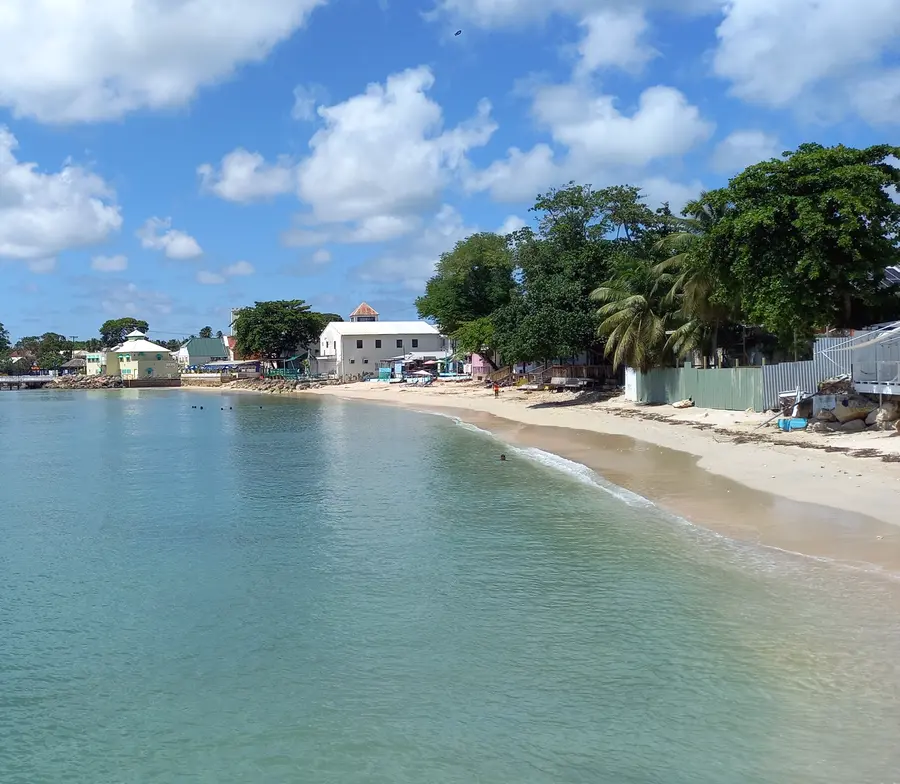 Bars line the white-sand shores on a tranquil beach in Speightstown