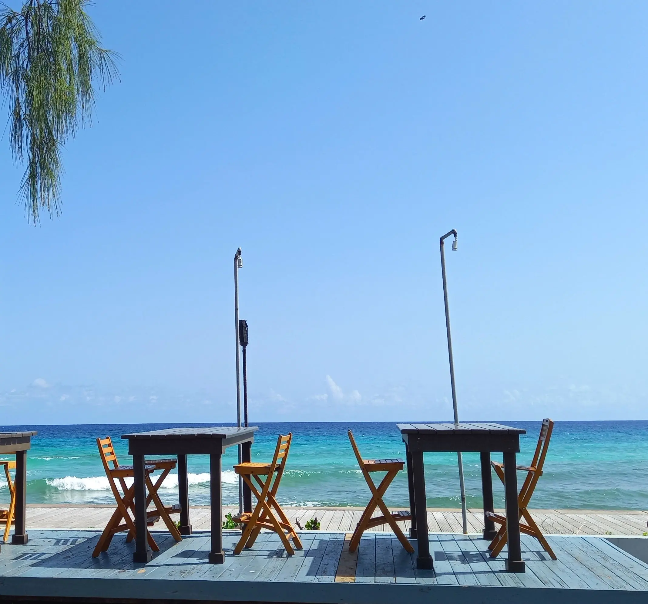 Table with a boardwalk and ocean view alongside the boardwalk